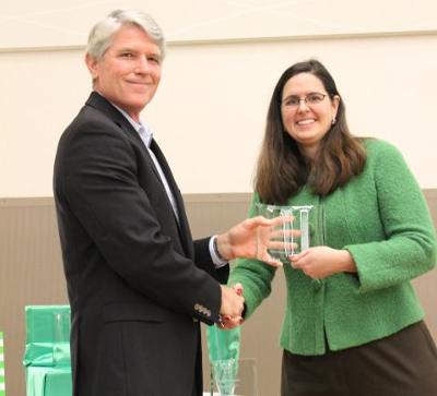 UNT staff member receiving a plaque at the ceremony
